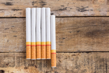 Cigarette roll on old wooden table background