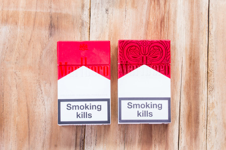 PHARE, THAILAND - MARCH 9, 2016. Pack of Marlboro Cigarettes on Wooden Table, made by Philip Morris. Marlboro is the largest selling brand of cigarettes in the world.のeditorial素材