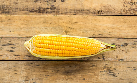 Fresh corn on a wooden table background