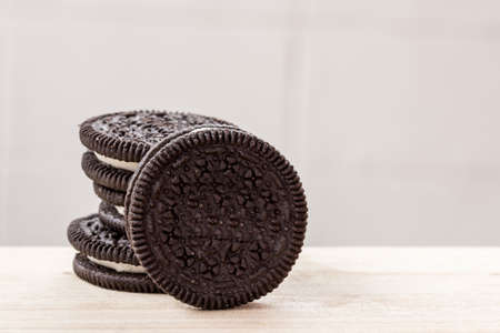 Chocolate chip cookies on a wooden table with blurred background.の写真素材