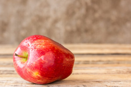 Close up fresh red apple on wooden table