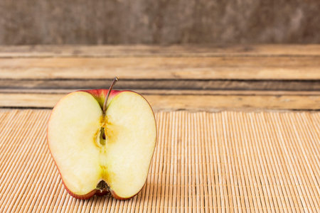 Slice half fresh apple on old wooden table background