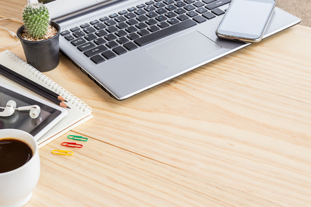 Office desk table with laptop computer, coffee cup and smart phone. Top view with copy space.の写真素材