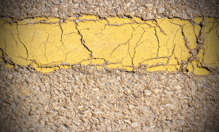 Close up yellow line on road texture and background for any designの写真素材