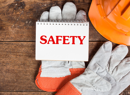 White card in  safety glove with the inscription SAFETYの写真素材