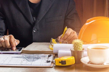 Business man working and coffee cup in office with morning sunlight. Vintage tone Retro filter...