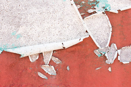 A wall with peeling plaster red color.Vintage wall background of natural cement or stone old texture as a retro pattern wall.の写真素材