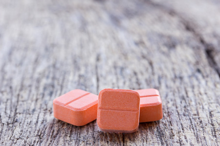 Close up pills on a wooden table background with copy space. Health conceptの写真素材