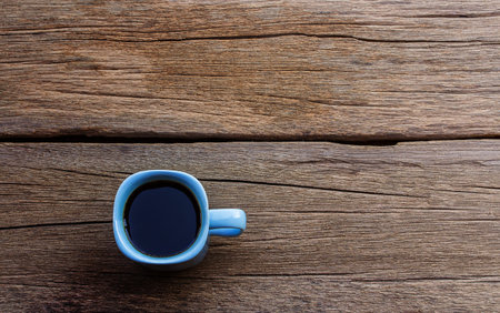 Coffee cup on old wooden table background with copy space. top viewの写真素材