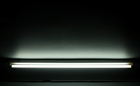 Detail of a fluorescent light tube on a wall. fluorescent light tube with copyspace for any designの写真素材
