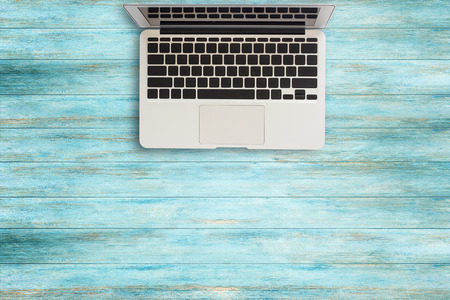 Laptop computer on wood table top view with copy space.Office supplies and gadgets on desk table.の写真素材