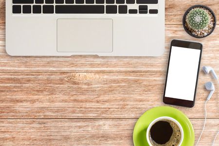 Desktop with laptop computer,smart phone,coffee cup and office supplies  with copy space. Concept for website banner and marketing materialの写真素材