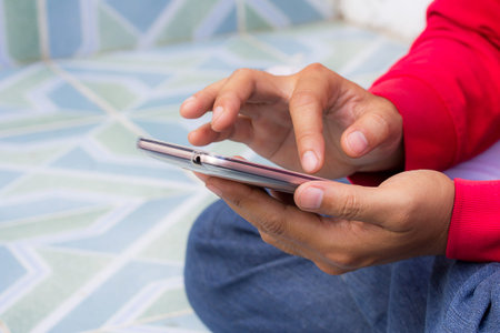 Male hand holding smart phone with copy space