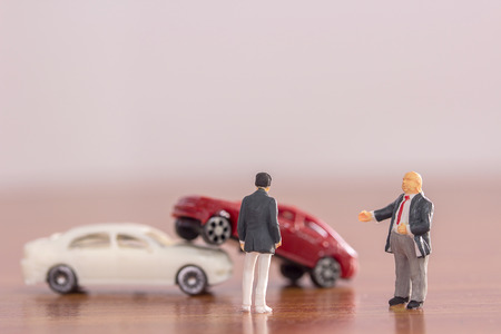 Miniature car- Miniature car crashed car in a city with blurred background. Businessmen are negotiating for auto insurance. Accident and insurance concept.の写真素材