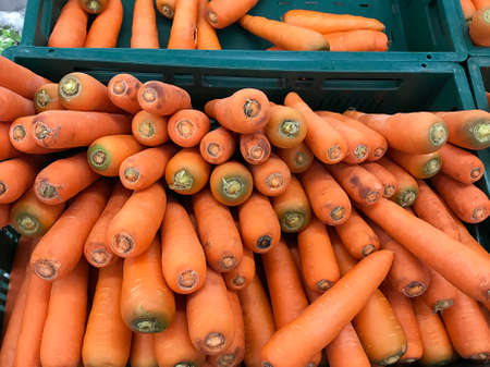 Closeup pile of fresh carrots at for display at supermarket. health eating concept.の写真素材