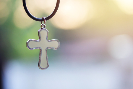 Christian cross with blurred bokeh light background with morning sunlight, christian concept Jesus is the light of the world, Copy space for designの写真素材