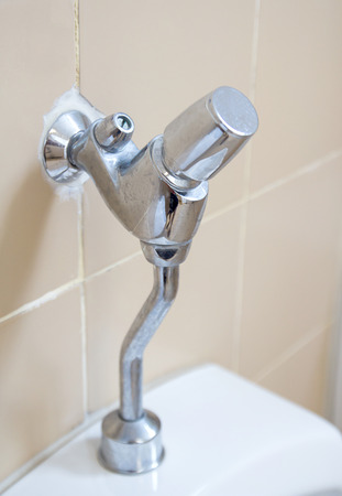 Close up of modern bathroom tap with shower in contemporary homeの写真素材