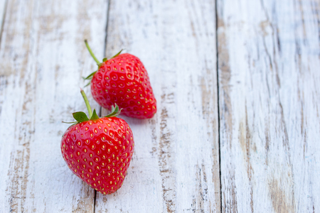 Fresh strawberries on old white wooden background. Top view with copy space. nature fruit concept and healty eating.の写真素材