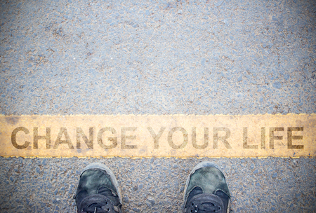 Male feet and old black shoes standing on the concrete floor or street asphalt pavement with dividing line. Space for text and design and Change your life Conceptの写真素材