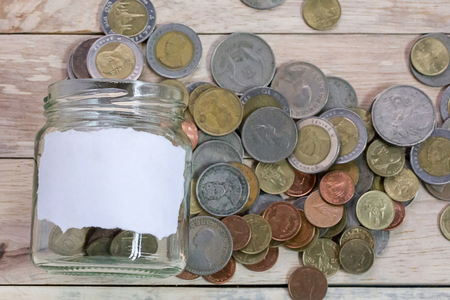 Close up saving money into a glass jar for cash in future investment. Money and financial concept.の写真素材