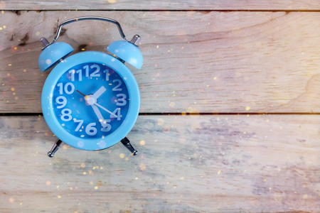 Retro vintage alarm clock on wood tableの写真素材