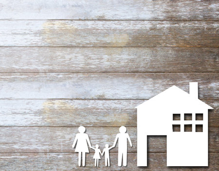Family, the house of paper on wooden table background. real estate, family values. Top view with copy space for your design.
