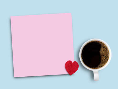 Colorful pink sticky note,red paper heart and cup of coffee on blue table background. Father's day and valentine's day concept design.の写真素材