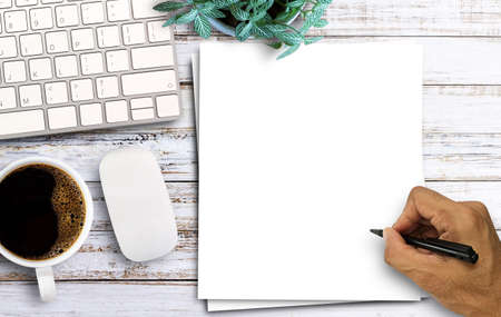Top view with blank white paper,coffee,keyboard computer on wooden table background. space for any design.の写真素材