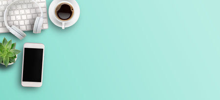 Top view with call center desktop,headset,smartphone and accessories on green background. Panoramic banner for business marketing design. copy spaceの写真素材