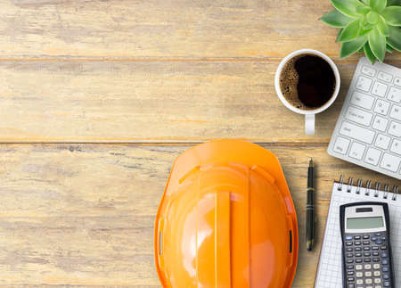 Top view financial accessories,salfety helmet and stationery supplies on office desk in office workplace. Business and financial and father day concept.の写真素材