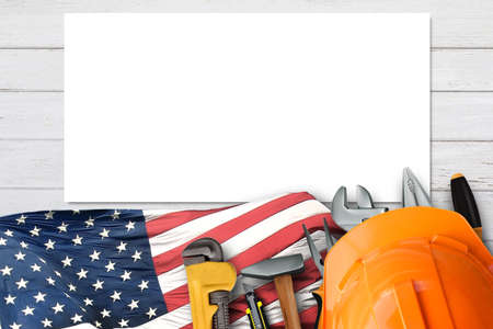 Top view design concept of Labor Day with working tools.safety helmet,usa flag on white wood table background.の写真素材