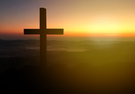 Silhouette christian cross on mountain in sunrise background.Jesus Christ cross.の写真素材