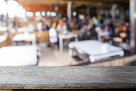 Wood table with coffee shop blurred background with copy space for design.の写真素材