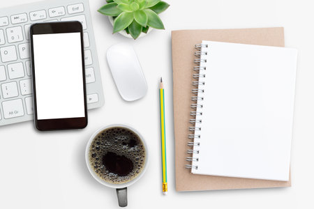 Smartphone,mini keyboard,mouse and notebook on white office desk background. Top view with copy...