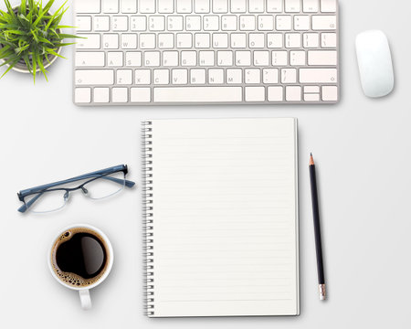 flat lay Blank notebook, computer keyboard,coffee,glasses and other office equipment on white office desk. Top view with copy space.の写真素材