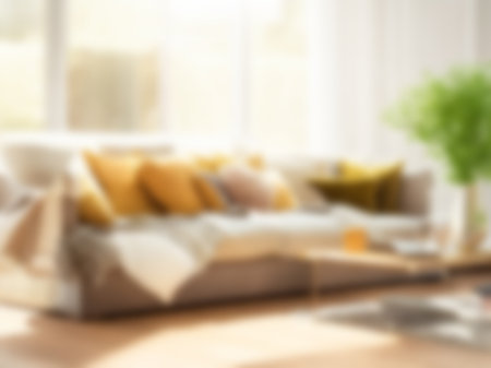 Blur living room at home with morning sunlight at big window for background usage. blur interior background concept.britht tone.の素材