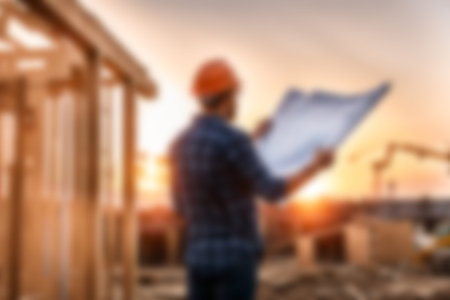 Blur images of workers in construction site. Silhouette Engineer and construction team working at site.の素材