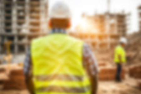 Blur images of workers in construction site. Silhouette Engineer and construction team working at site.の素材