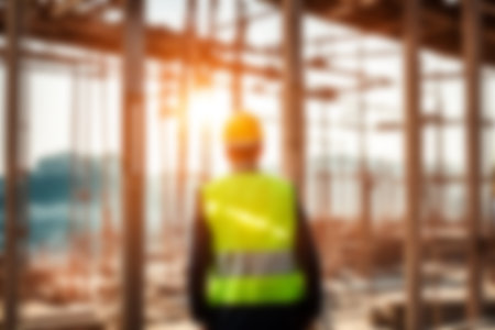 Blur images of workers in construction site. Silhouette Engineer and construction team working at site.の素材