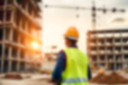 Blur images of workers in construction site. Silhouette Engineer and construction team working at site.の素材