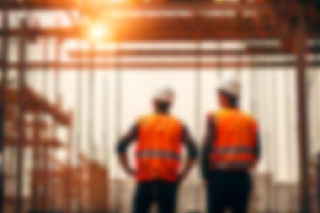 Blur images of workers in construction site. Silhouette Engineer and construction team working at site.の素材