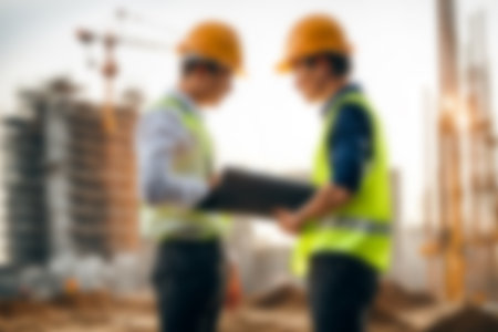 Blur images of workers in construction site. Silhouette Engineer and construction team working at site.の素材