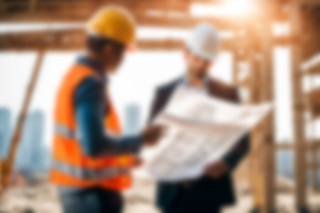 Blur images of workers in construction site. Silhouette Engineer and construction team working at site.の素材