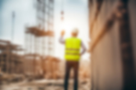 Blur images of workers in construction site. Silhouette Engineer and construction team working at site.の素材