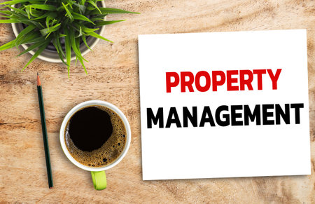 Business quotes, PROPERTY MANAGEMENT on notebook or paper in office desk, office workplace, inspiration, motivation quotes concept.の写真素材