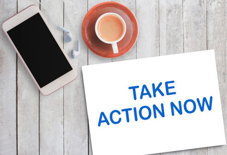 Business quotes, take action now on notebook or paper in office desk, office workplace, inspiration,...