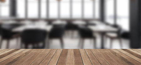 Empty wood tabletop or counter with display product. Blur image of restaurant interior background....