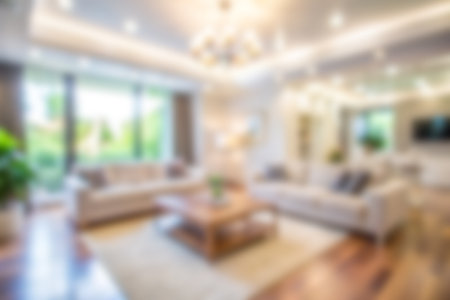 Blur living room at home with morning soft sunlight at big window for background usage. blur interior background concept. bright tone.の素材