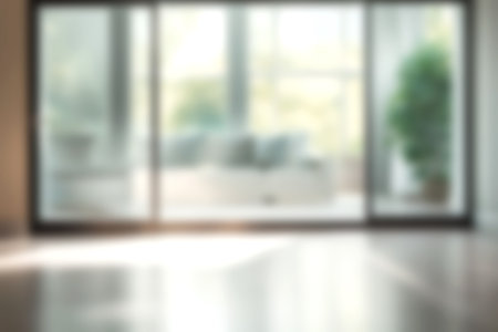 Blur living room at home with morning sunlight at big window for background usage. blur interior background concept. white, britht tone.の素材