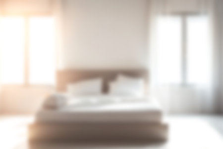 Blur modern bedroom at home with morning soft sunlight at big window for background usage. blur interior background concept. white, bright tone.の写真素材